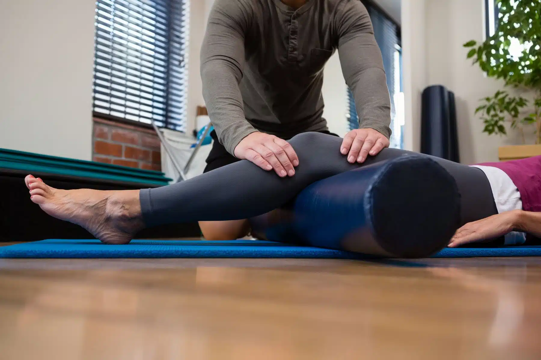 physiotherapist giving physical therapy of leg