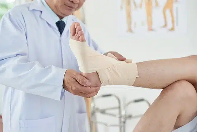 bandaged foot examined by a doctor