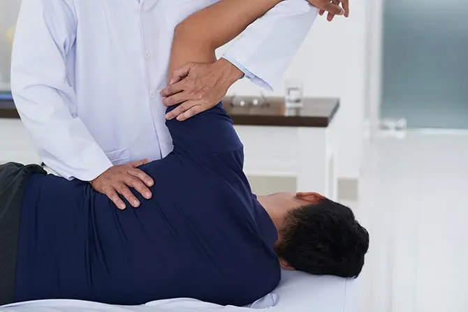 Chiropractor doing the flexion distraction therapy