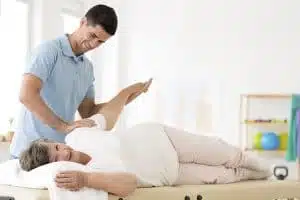 A senior patient treated by a physiotherapist