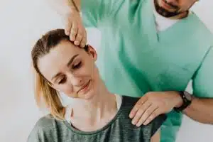 female patient getting her neck adjustments from a chiropractor