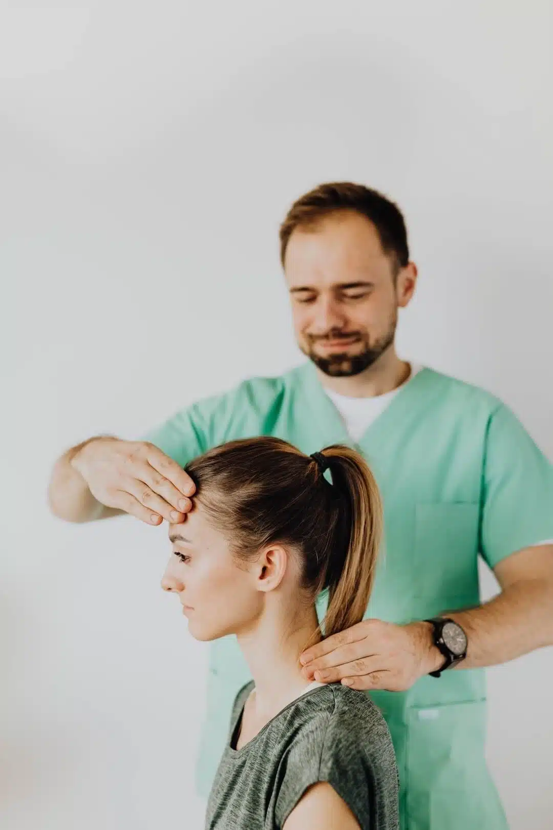 chiroprctor adjusting a female patient's back