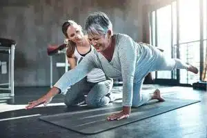 An older woman practicing yoga to help manage pain