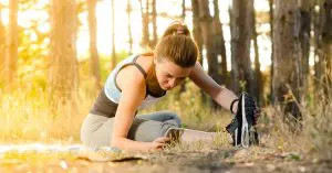 A woman stretching her leg to help with back pains