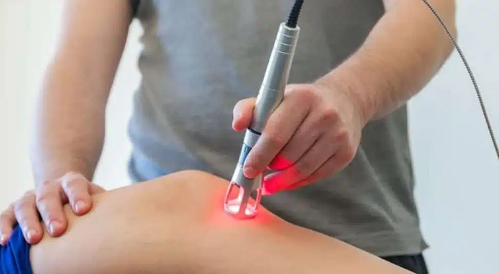 Male patient being treated with cold laser therapy.