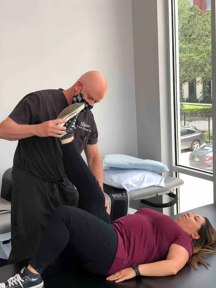 physiotherapist doing stretches on female patient