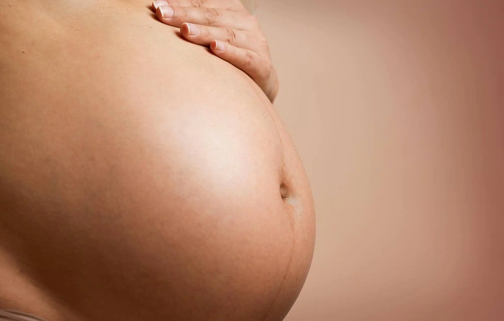 Pregnant woman holding her belly